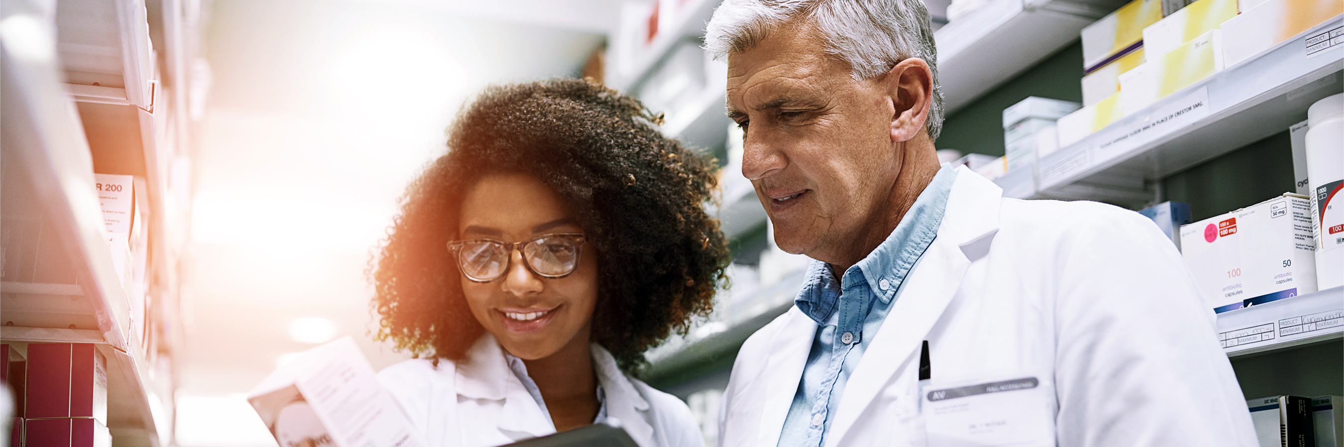 A Pharmacist and Pharmacist Tech work together