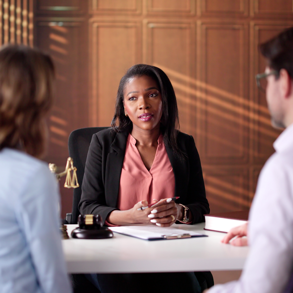 A lawyer meets with two clients