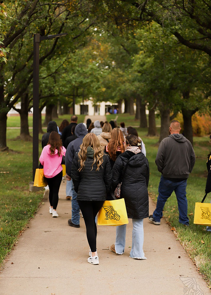 Students walking along a sidewalk on campus
