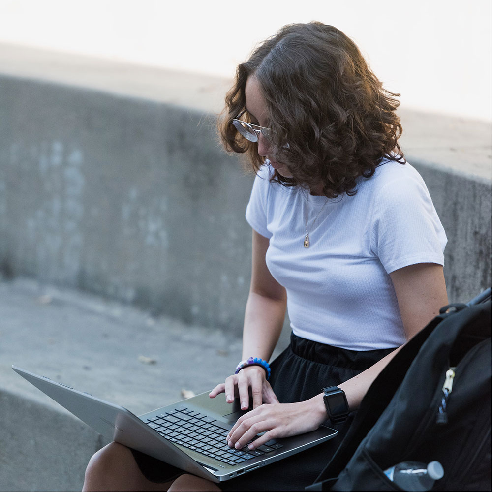 Student working on a laptop outside