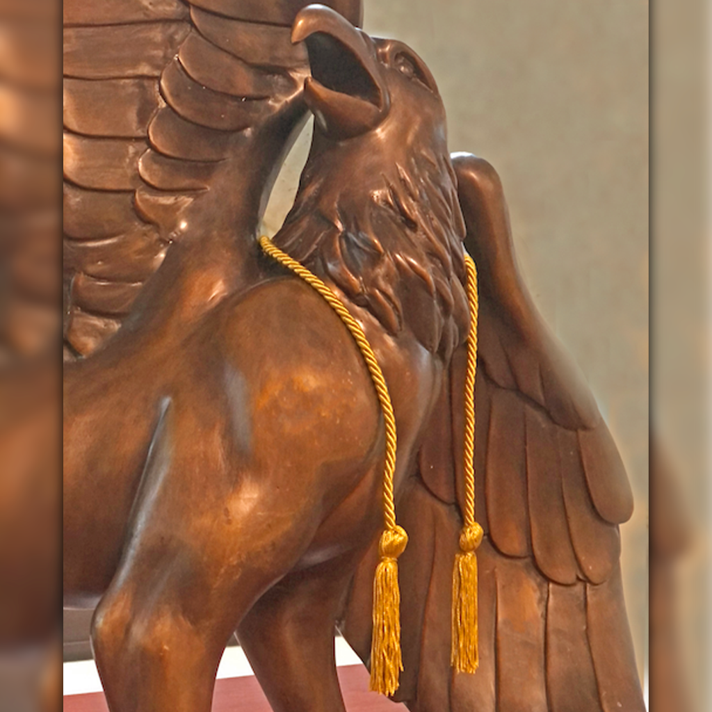 Griffon Statue with a legacy gold cord around neck