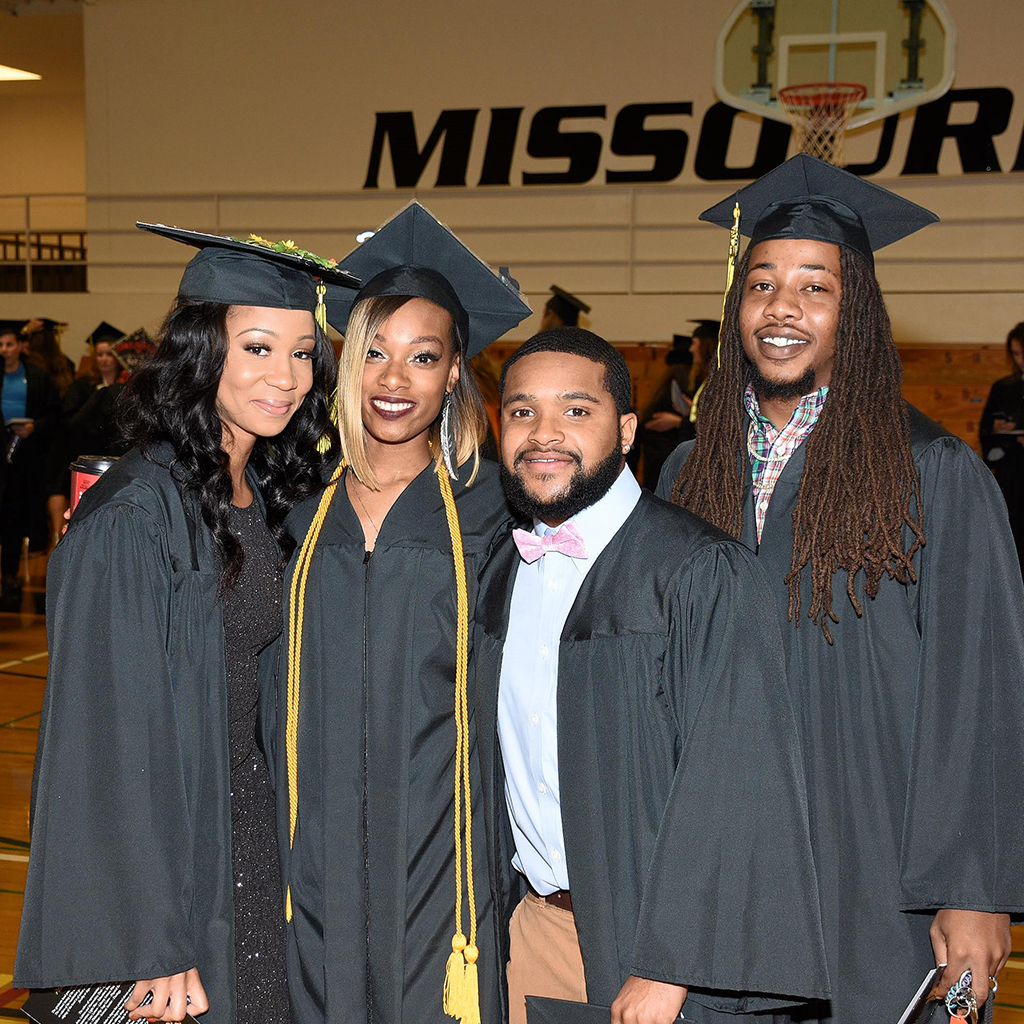 graduates standing in the looney gym