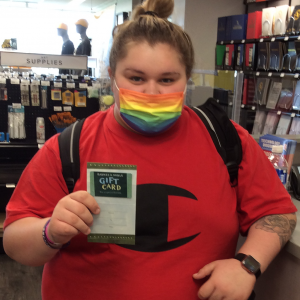 shelby emory at student store holding a gift card