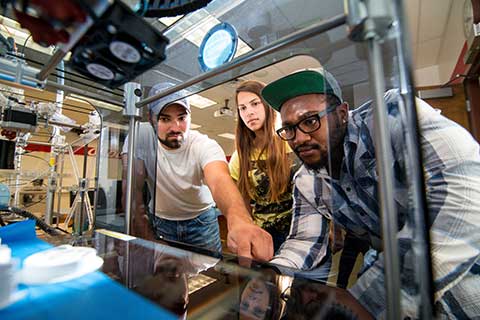 Students work on engineering equipment