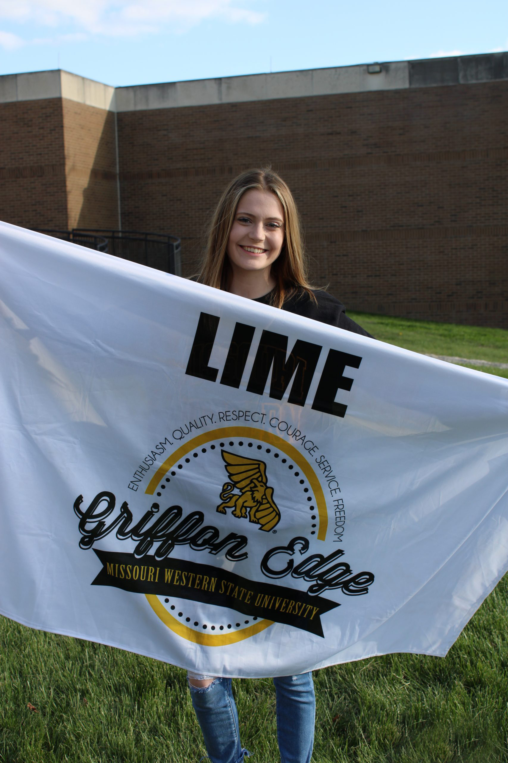 Student holding lime flag