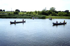 Children canoeing at a campus pond
