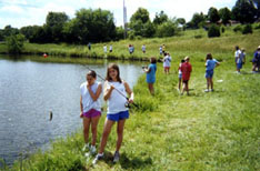 Children fishing at a campus pond