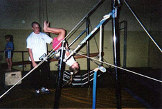 Child playing on the uneven bars