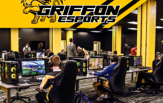 Esports statium filled with students competing in a game with griffon esports logo