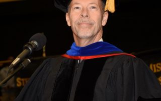 Dr. Doug Davenport standing a podium