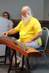 Fred Weems played the guzheng, a traditional Chinese instrument, during the 2014 Mid-Autumn Festival celebration.