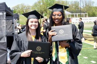 graduates display their diplomas