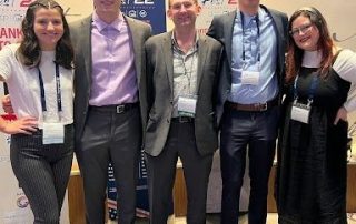 students and professor at conference