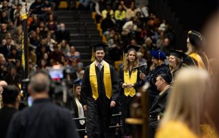 graduate crosses stage