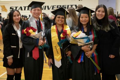 graduates hold flowers