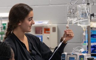 nursing student adjusts IV