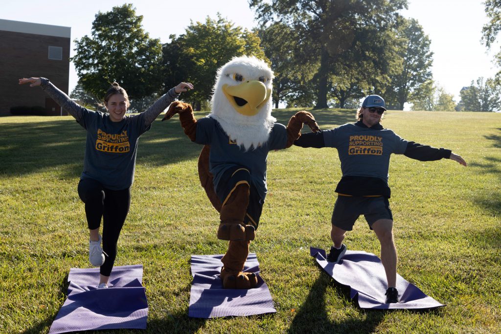 max the griffon and two others do yoga poses outdoors