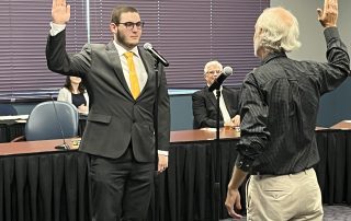 student governor takes oath of office in board room