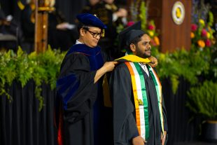 graduate student hooded by faculty member