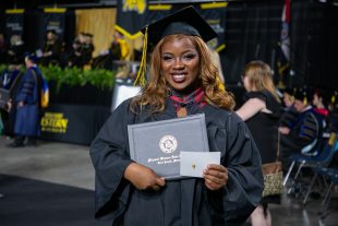 smiling graduate with diploma
