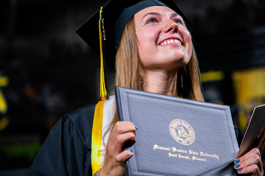 smiling graduate with diploma