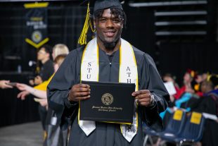 graduate with diploma