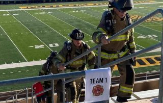 firefighters climb Spratt Stadium stairs