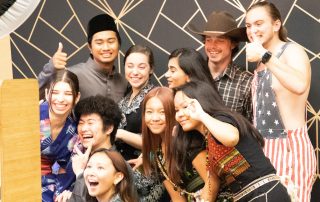 students in clothing from different cultures pose