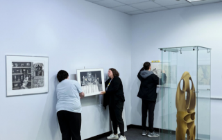 art students hang gallery exhibit