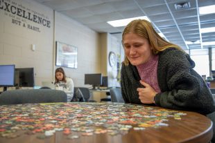 student with jigsaw puzzle