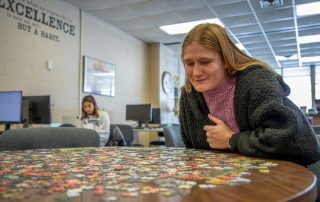 student with jigsaw puzzle