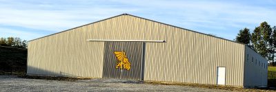 metal building with Griffon on overhead door