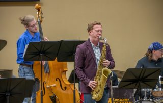 jazz saxophone, upright bass and drum performers