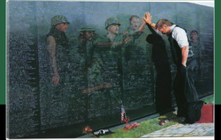 painting of veteran at Vietnam memorial wall
