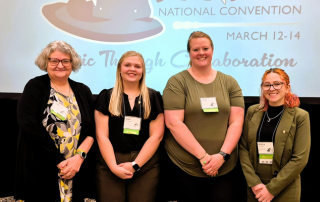 students pose at convention