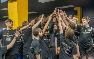 camp students and staff huddle in esports