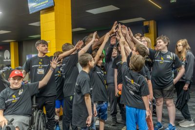 camp students and staff huddle in esports