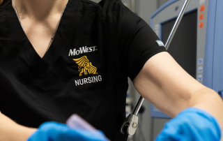 nursing student cares for mannequin