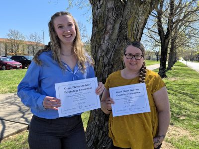 students with award certificates outdoors