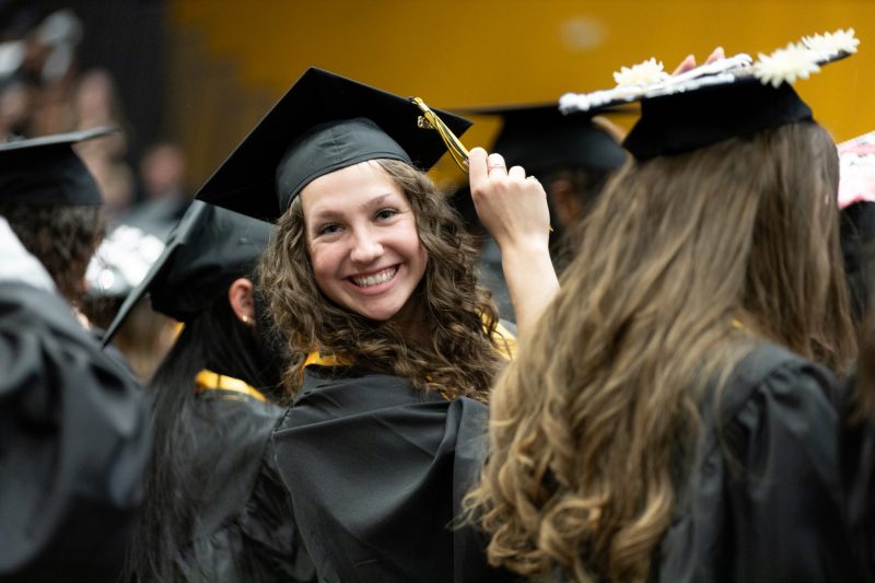 smiling graduate turns her tassel