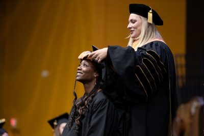 student receives graduate hood