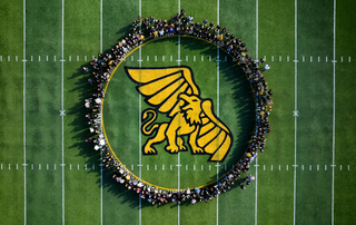 students on field at Spratt Stadium