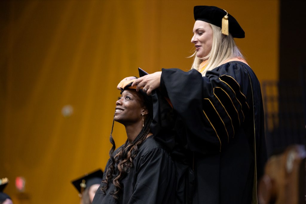 student receives graduate hood