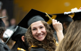 smiling graduate turns her tassel