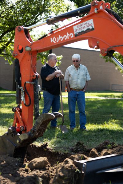 two men and an excavator