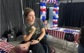 student massages service members shoulder