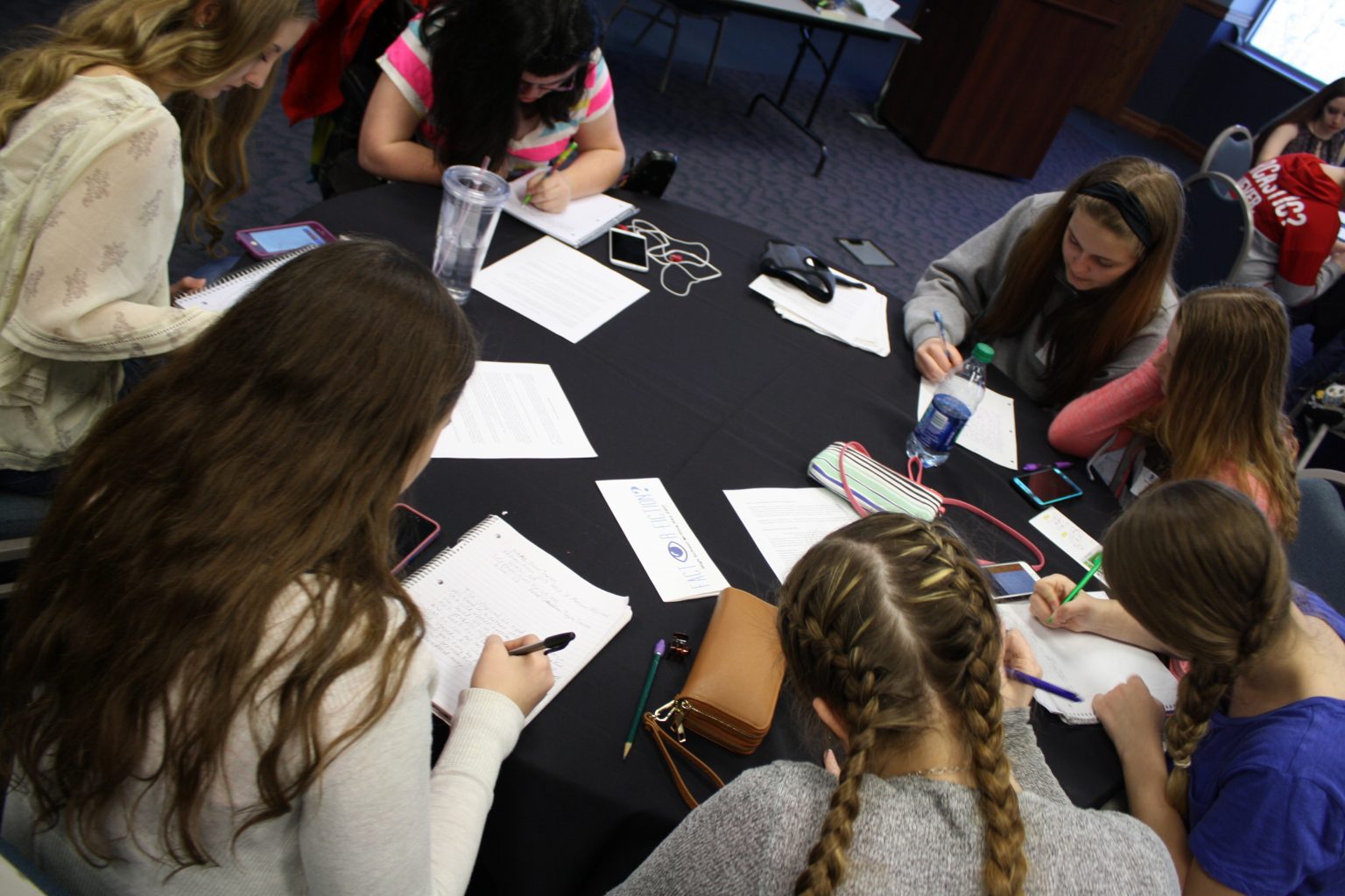 students write around table