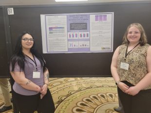 Justice Galloway (left) and Ashlyn George during their poster presentation.