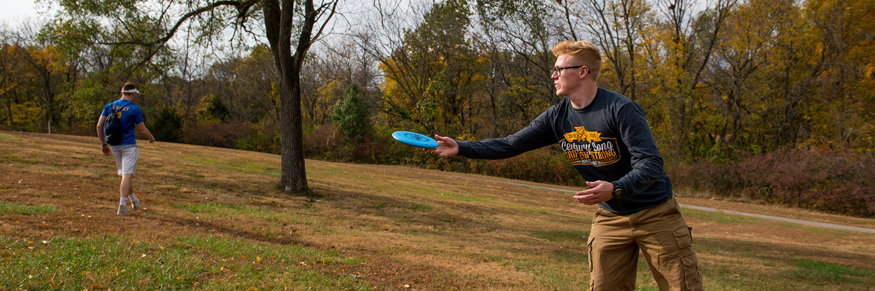 two students passing a frisbee