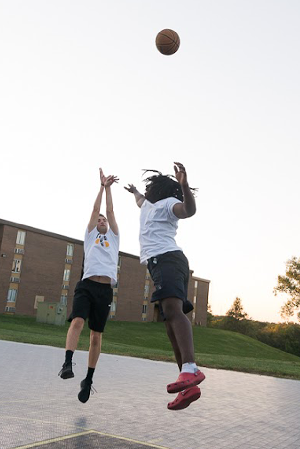 Two Students playing basketball